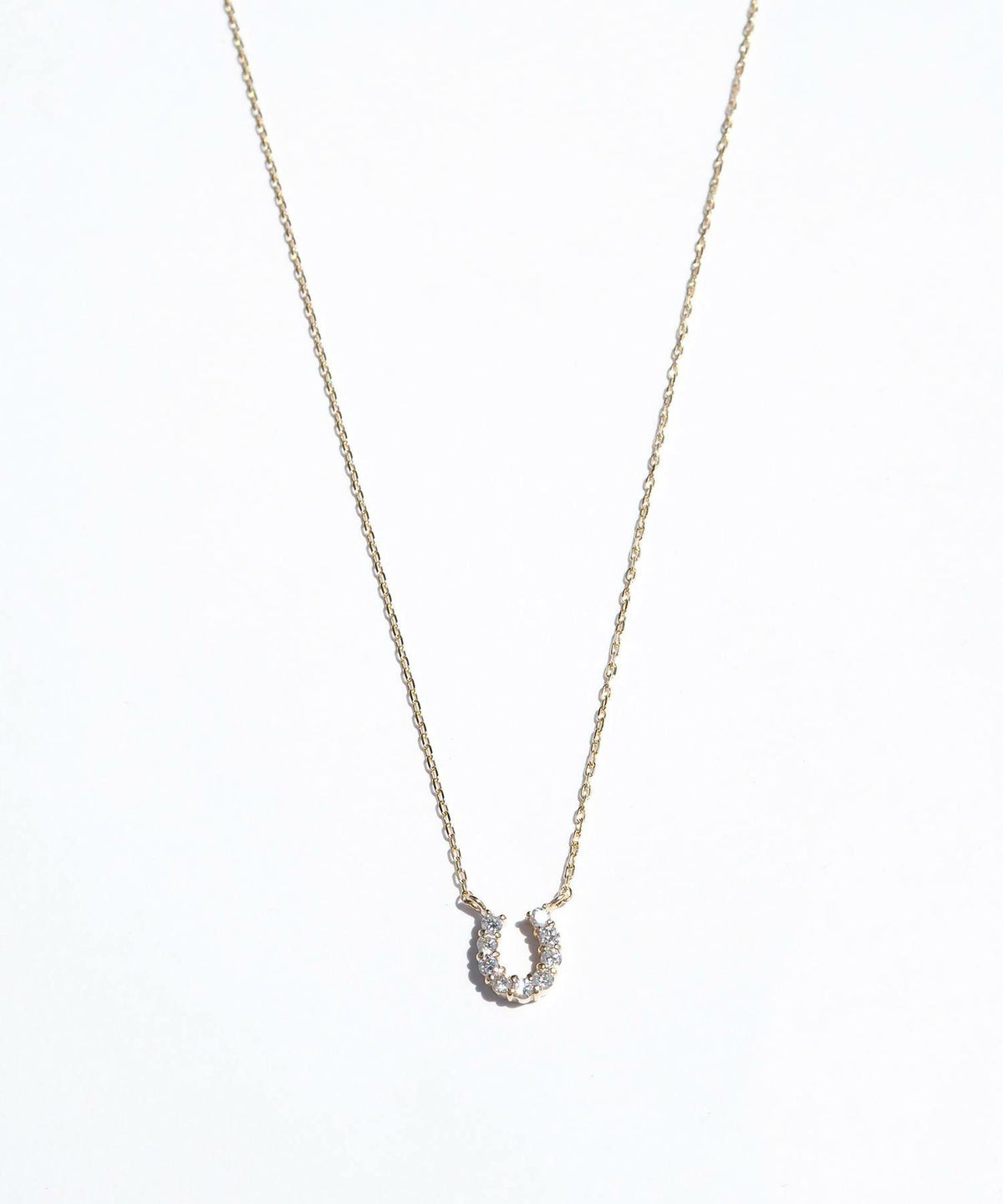 [K10]タイニーホースシューパヴェダイヤモンドプチペンダント【cucia】